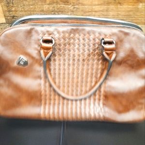 Brown faux leather, doctor style with Western flare purse.